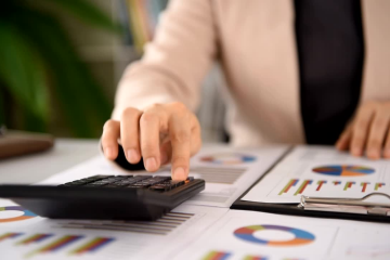 A professional desk setup featuring organized accounting files, both physical folders and digital devices, symbolizing efficient bookkeeping for small businesses in Broward County.